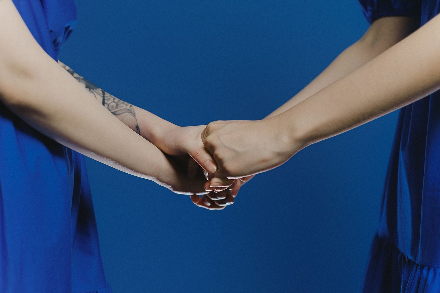 Two women holding hands